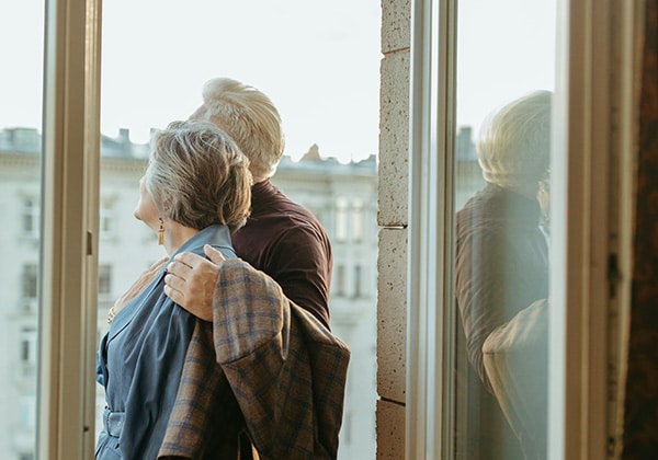 retired couple at a window in portugal
