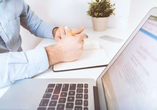 a person looking how to get Portuguese residency on a laptop