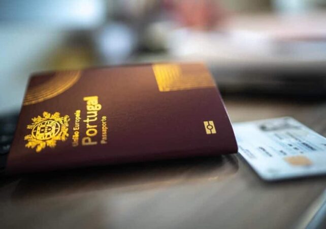A Portuguese residency card and passport on a table